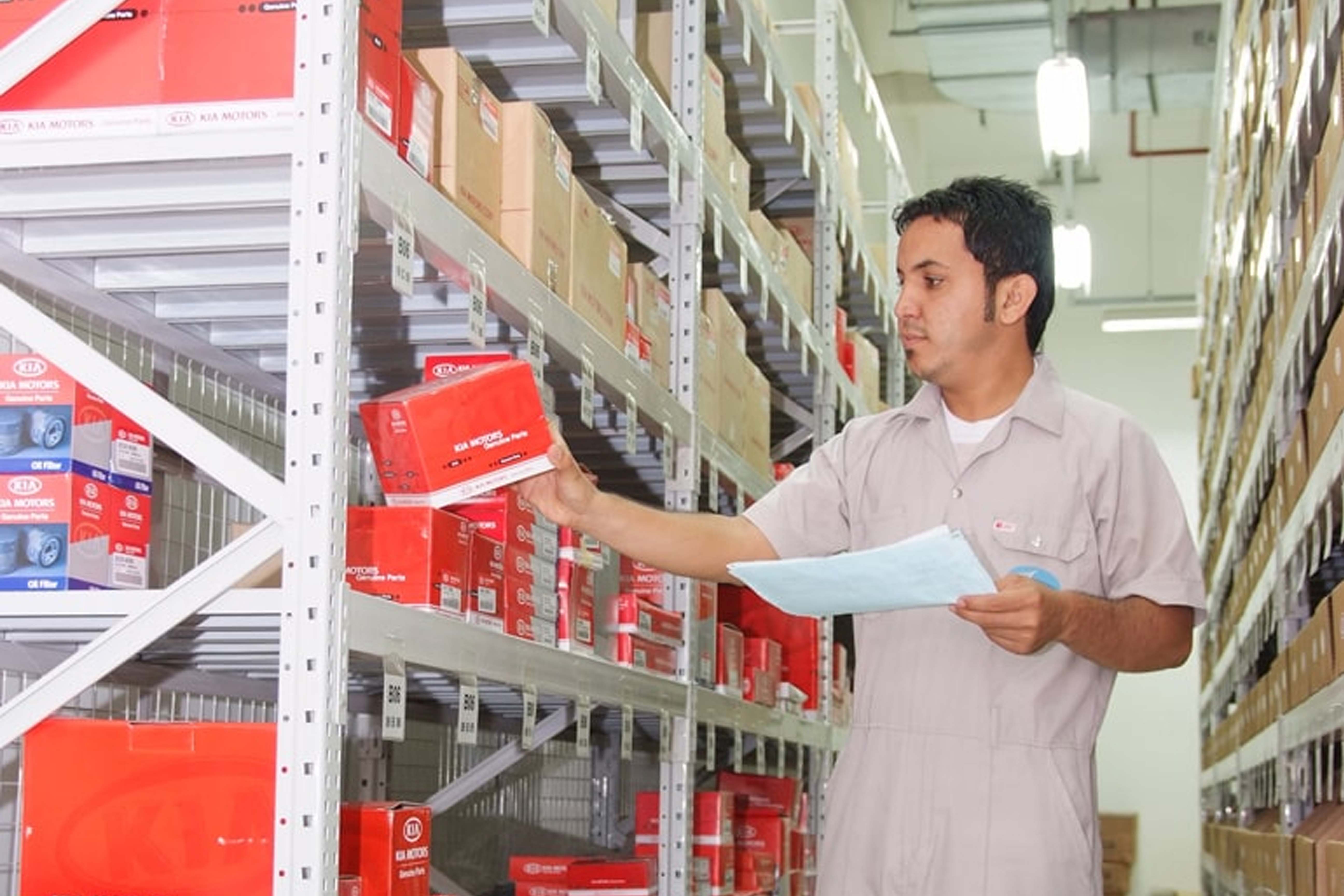 Saud Bahwan employee checking Kia parts inventory