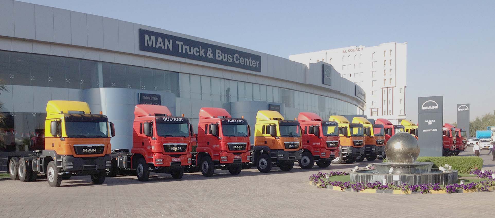 Multiple MAN trucks parked outside MAN truck and bus showroom